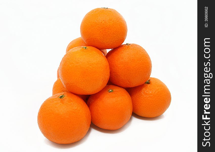 Pyramid from tasty ripe tangerines on a white background. Pyramid from tasty ripe tangerines on a white background.