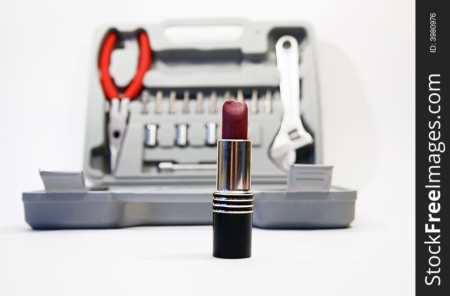 Lipstick on background with instruments' kit. Lipstick on background with instruments' kit