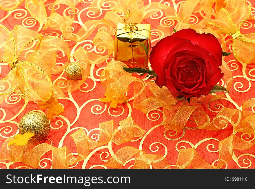 Holiday background with a gift and golden balls