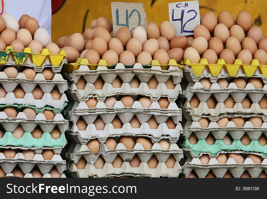 Stacks of fresh chicken eggs for sale in an outdoor marketplace. Stacks of fresh chicken eggs for sale in an outdoor marketplace