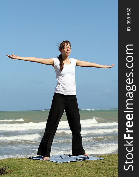 woman doing relaxing and yoga exercises on the beach. woman doing relaxing and yoga exercises on the beach