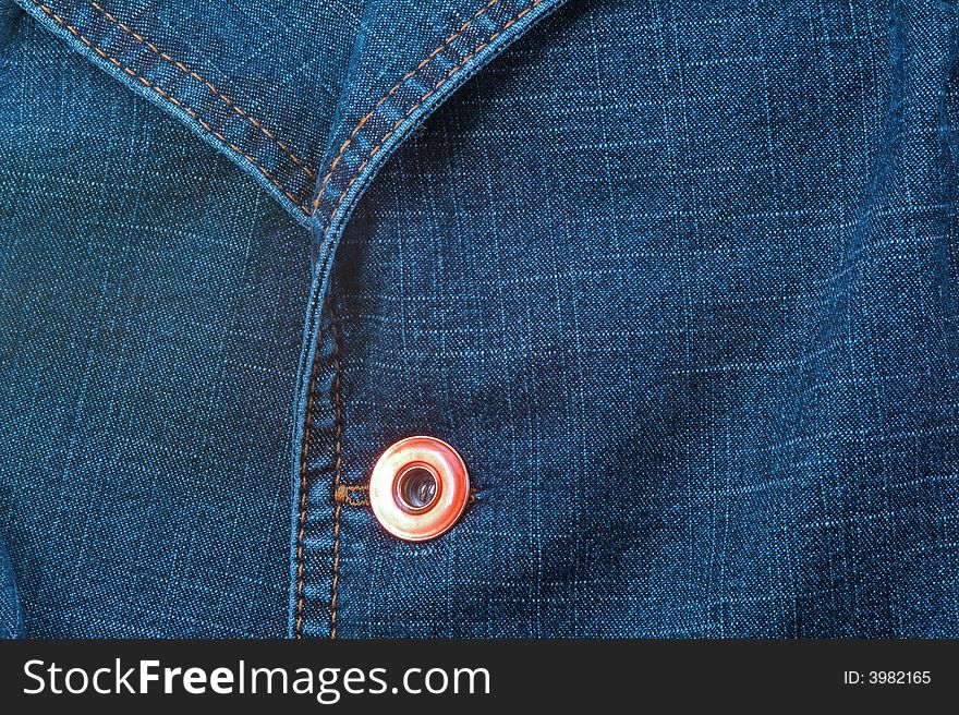 Close up of blue jeans jacket with button