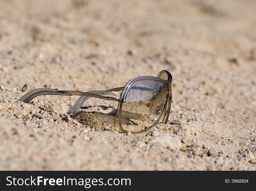 Sunglasses on the beachsand. Low depth of field.