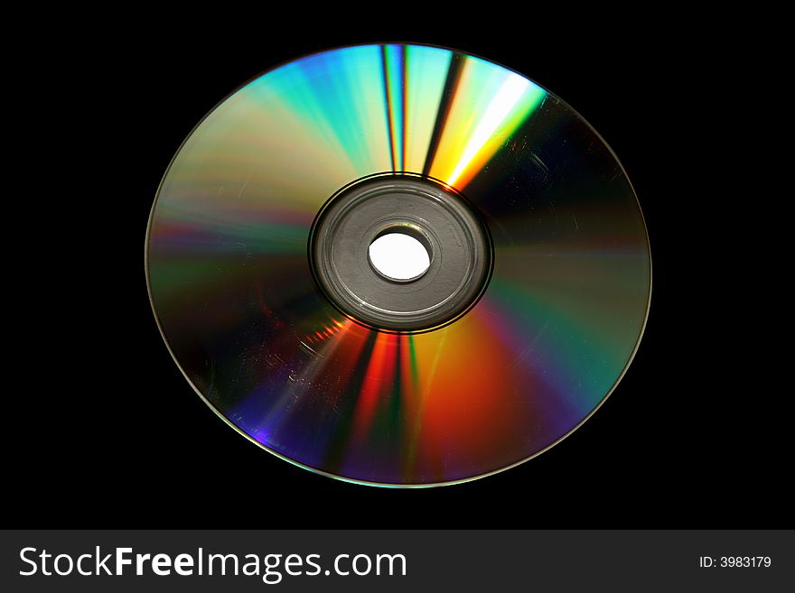 Old DVD disk (with clipping paths) on black background