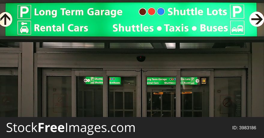 Green Parking Deck and Shuttle directional sign at an airport. Green Parking Deck and Shuttle directional sign at an airport