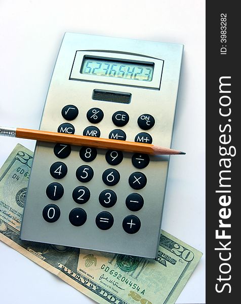 Calculator, pencil and twenty dollars bill on the table