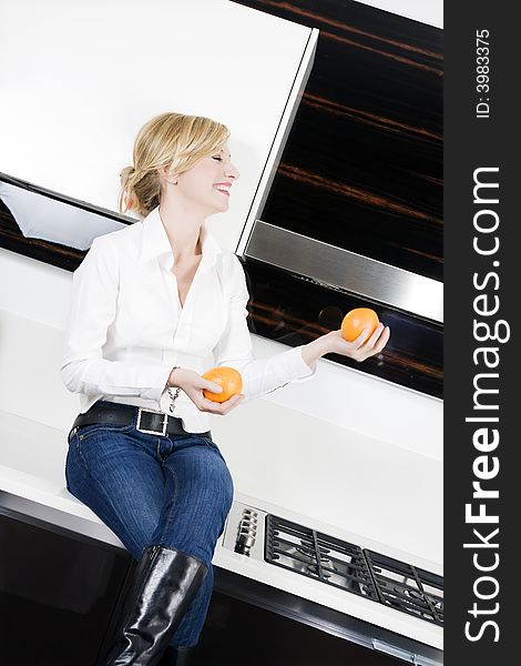 Home life: woman relaxing and playing with oranges