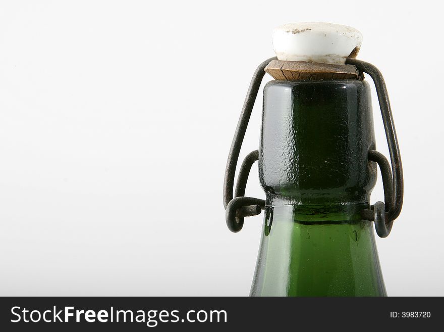 Antic top of a green bottle with cap. Antic top of a green bottle with cap