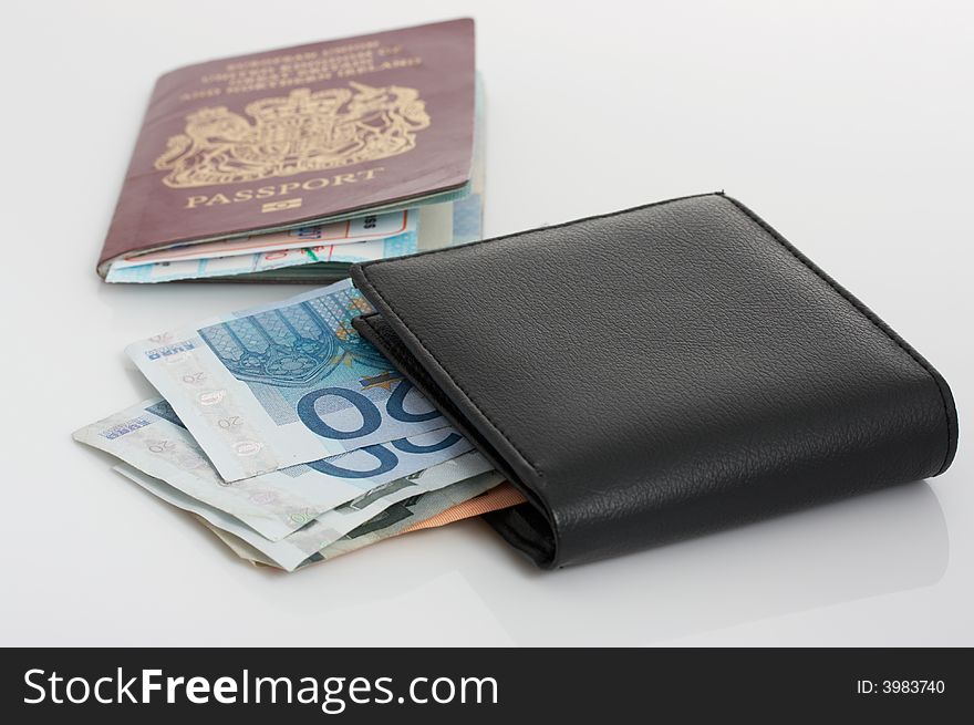 A passport and a wallet with euro bills. A passport and a wallet with euro bills