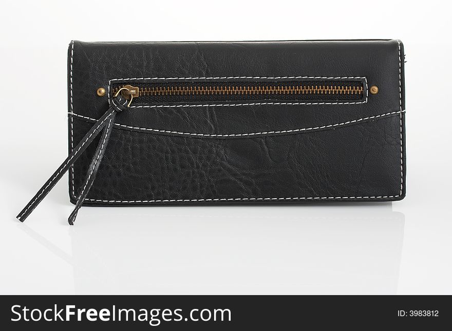 A black leather purse over a white background. A black leather purse over a white background