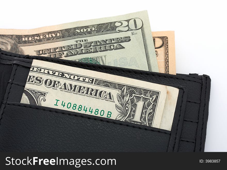 A wallet filled with several dollar bills. A wallet filled with several dollar bills
