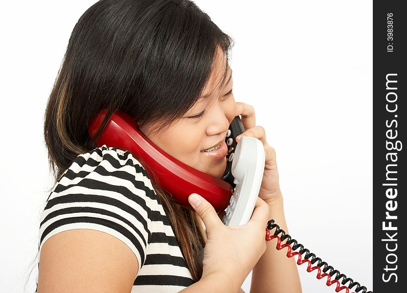 A woman answering multiple phones over a white background. A woman answering multiple phones over a white background