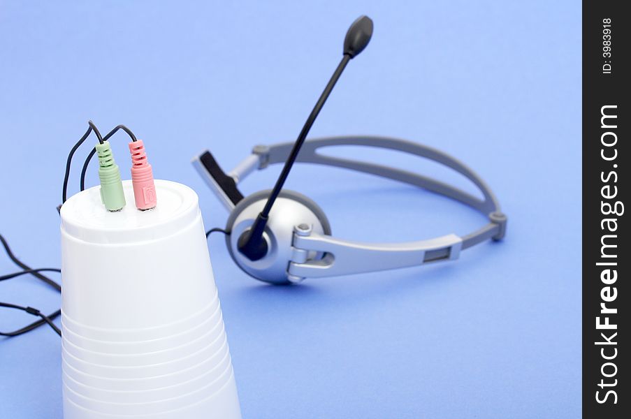 A computer headset over a blue background