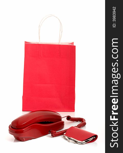 Photo of a telephone and a purse with a shopping bag on the background