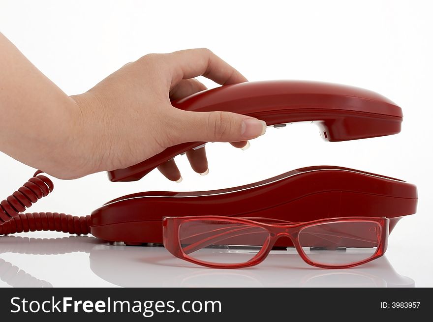 Photo of a telephone and eyeglasses over a white background