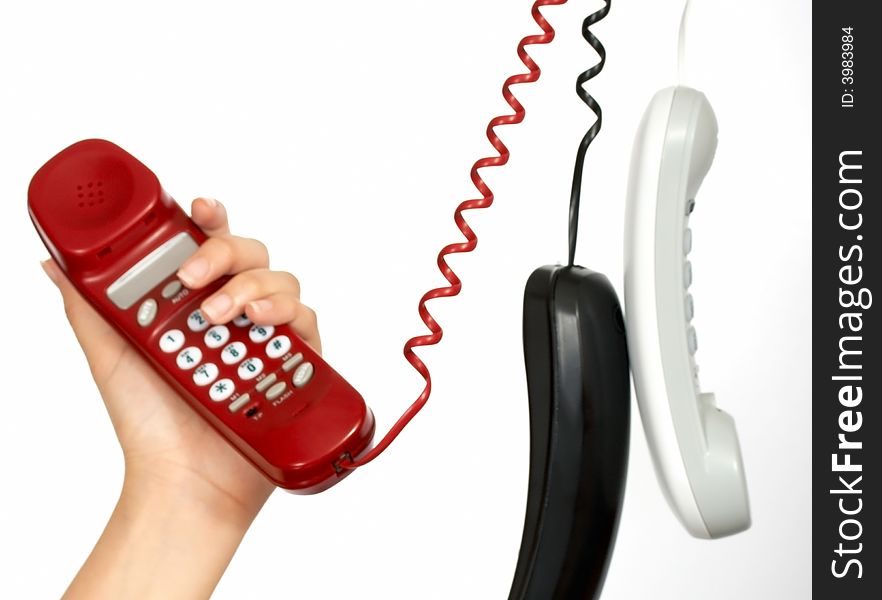 Handset phones hanging over a white background. Handset phones hanging over a white background