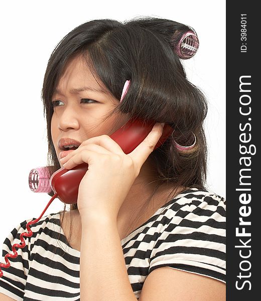 A woman with hair rollers making a phone call. A woman with hair rollers making a phone call