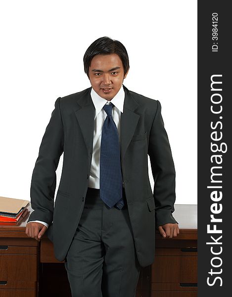 A man leaning on an office desk