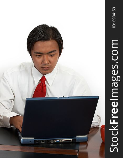 A man working on his laptop over a white background. A man working on his laptop over a white background