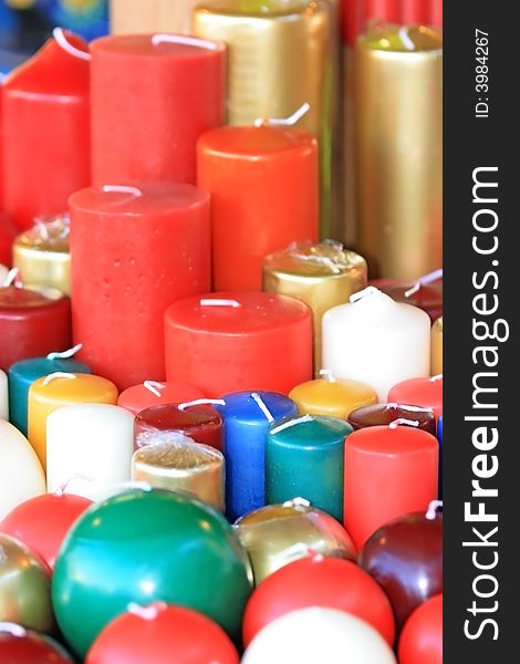 Candles of different form, color and size on a christmas market