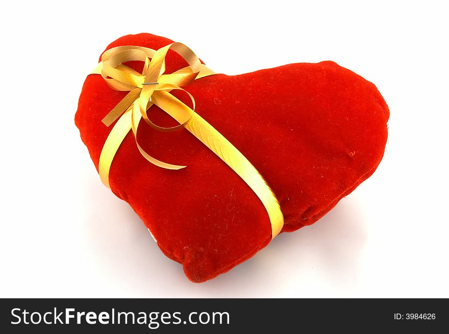 The heart which has been tied up by a tape with a bow. A gift on Valentine's day