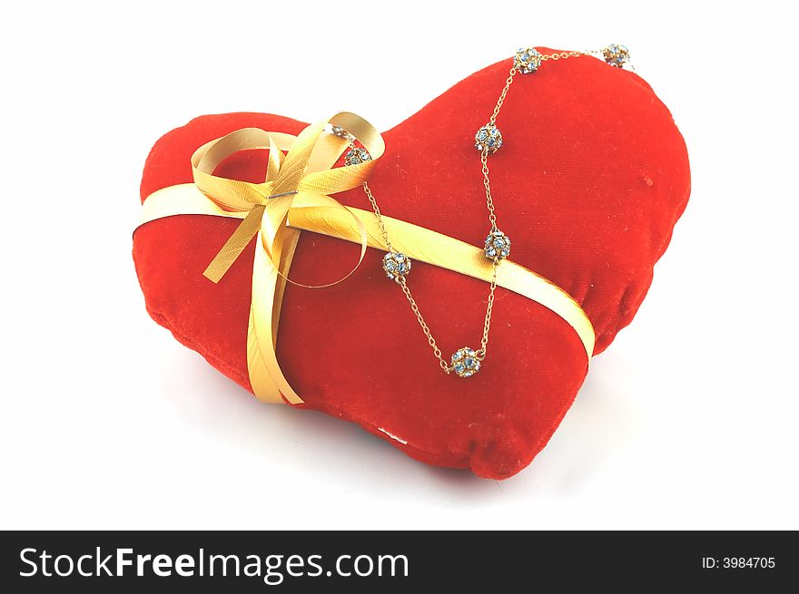 The heart which has been tied up by a tape with a bow. A gift on Valentine's day