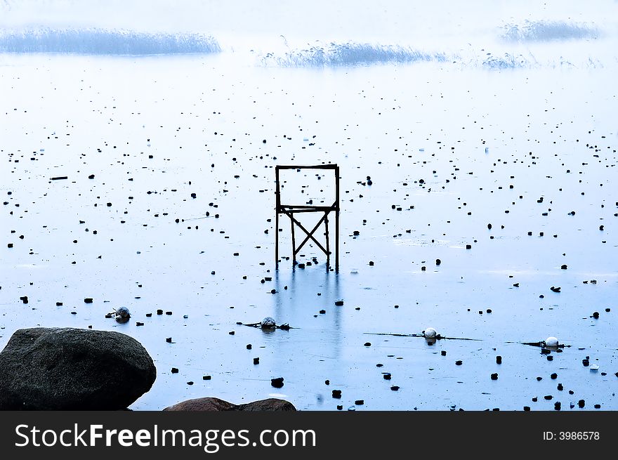 Chair on frozen lake