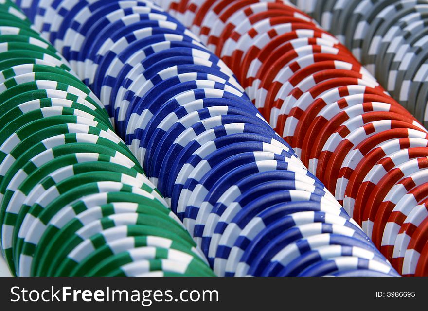 Abstract background with casino chips in five colors: red, blue, green, gray and white