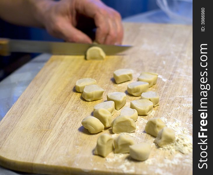 The cook is prepared with a dough for ravioli. The cook is prepared with a dough for ravioli