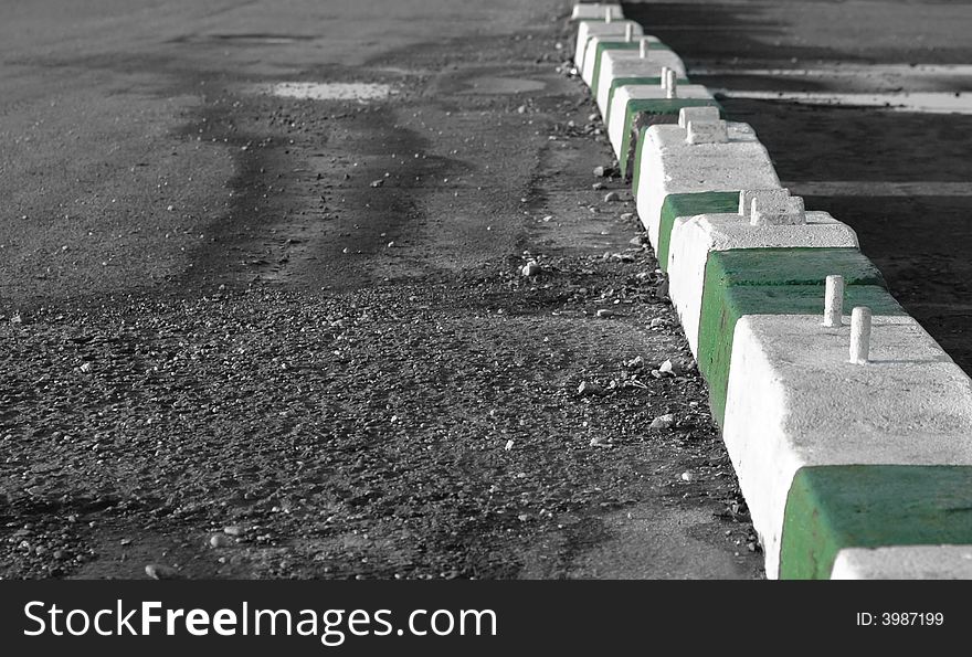 Heavy concrete traffic barricades on gravel car-park. Heavy concrete traffic barricades on gravel car-park