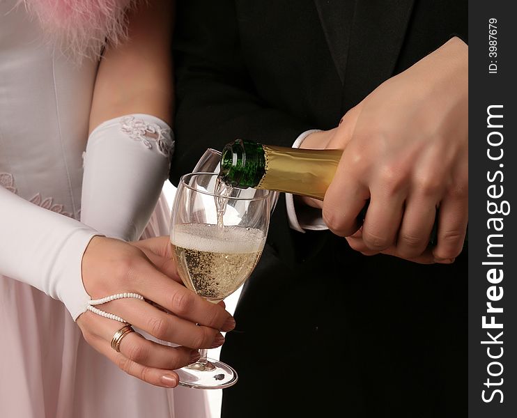 The two hands with a bootle of champagne