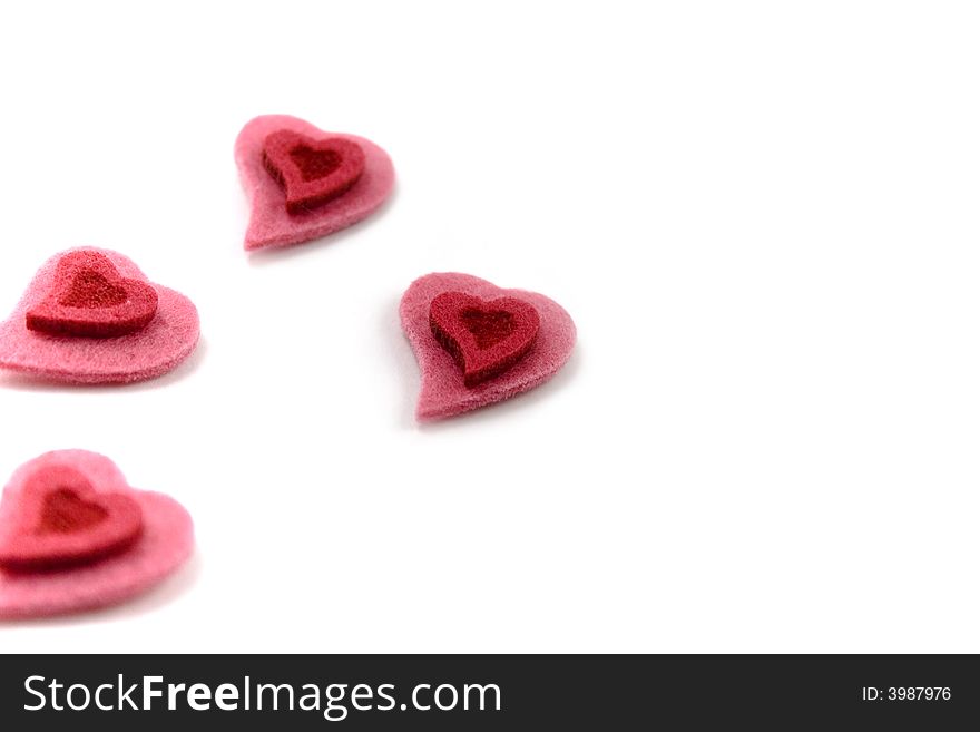 Four Valentine's hearts over white background