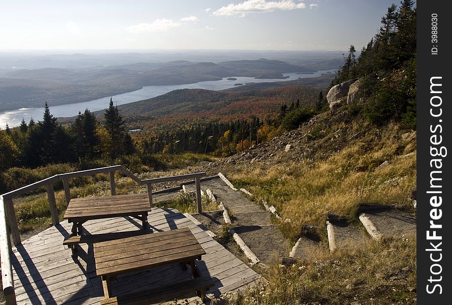 Hiking trail on the mountain, a picnic table with a colorful autumn scene. Hiking trail on the mountain, a picnic table with a colorful autumn scene