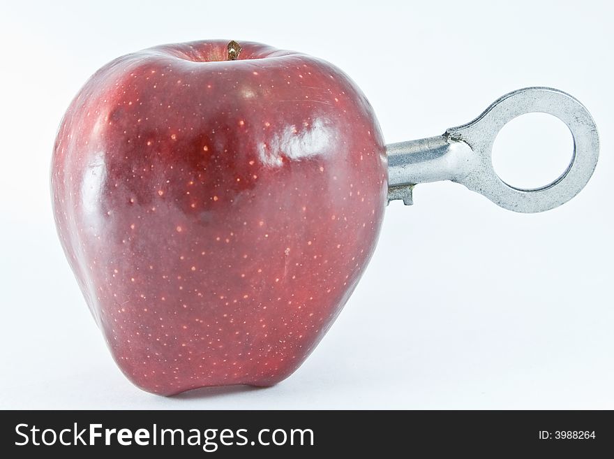 Apple with a key on white background