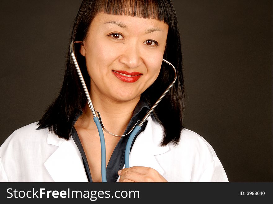 A female doctor with a stethoscope and holding a clipboard.