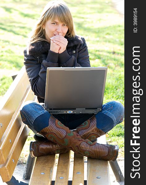 Young woman with laptop at the autumn park. Young woman with laptop at the autumn park