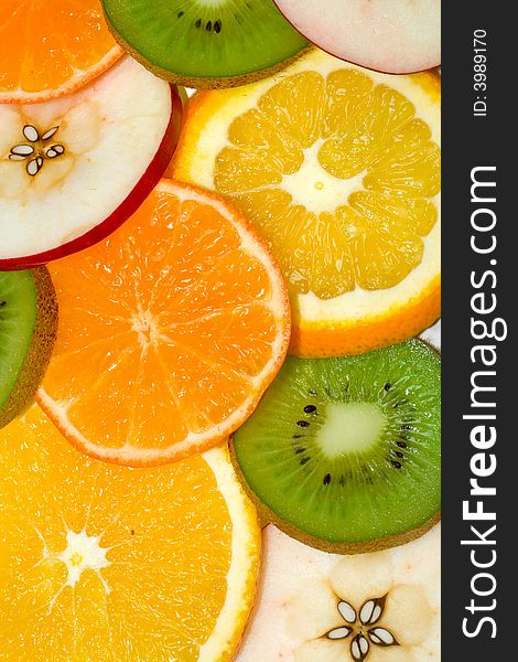 Fruits background from slices kiwi, apple, tangerine and orange. Fruits background from slices kiwi, apple, tangerine and orange