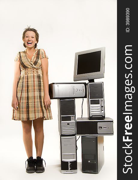 Beautiful young girl standing next to bunch of computers. Beautiful young girl standing next to bunch of computers