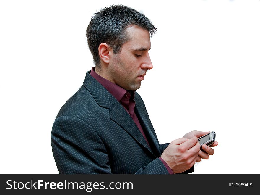 Young businessman typing with a stylus on a touchscreen mobile phone isolated on white background. Young businessman typing with a stylus on a touchscreen mobile phone isolated on white background