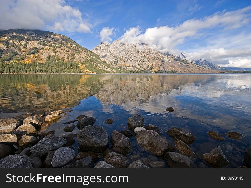 The Teton Mountains reflected in the calm waters of Jenny Lake, Wyoming.