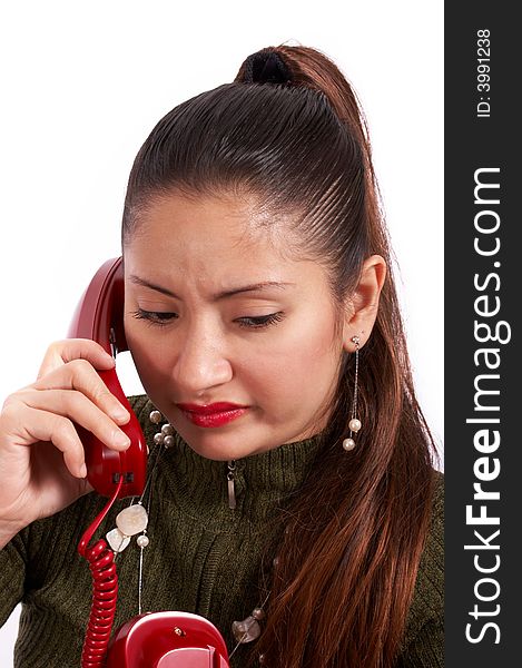 A young female talking on the phone looking annoyed. A young female talking on the phone looking annoyed