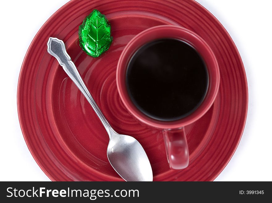 Coffee cup and saucer with leaf shaped chocolate from above. Coffee cup and saucer with leaf shaped chocolate from above