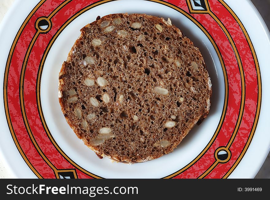 Rye bread with seeds on the plate. Rye bread with seeds on the plate.