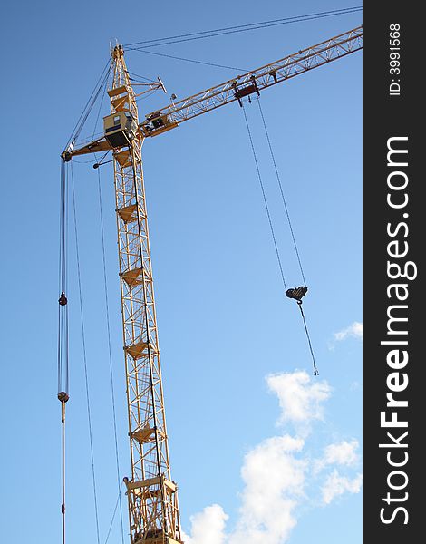 Building tower crane on blue sky