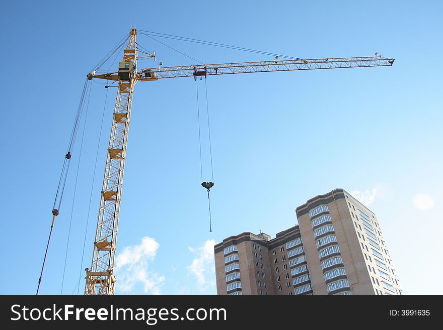 Building tower crane on blue sky