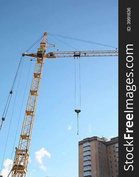 Building tower crane on blue sky