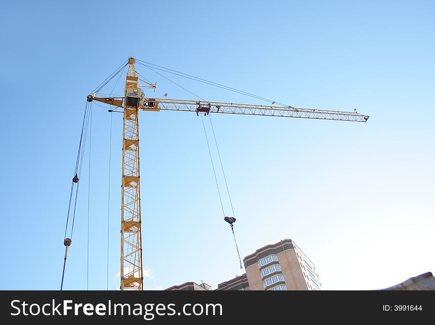 Building tower crane on blue sky