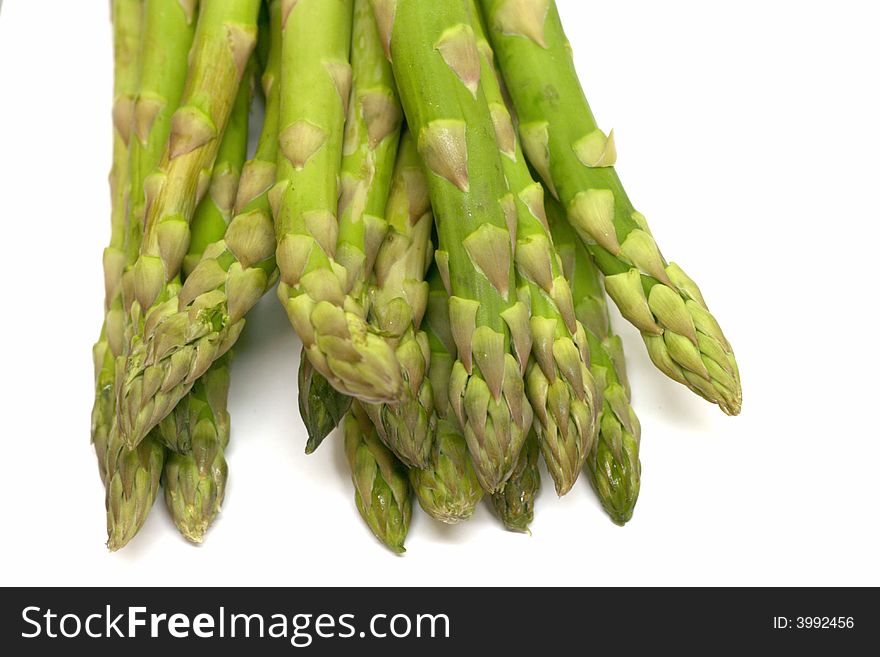 Fresh green asparagus on a white background with shallow DOF