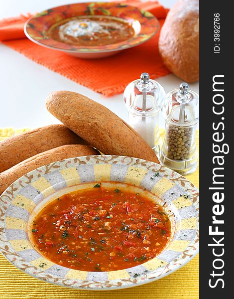 Chunky homemade tomato soup with chopped basil and garlic and a dash of olive oil