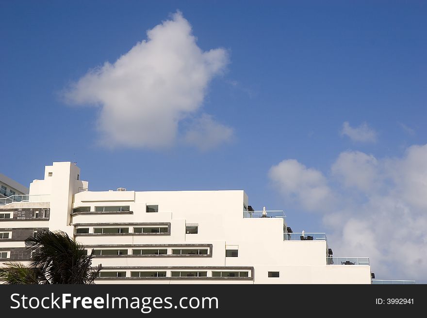 White Terraced Hotel And Clouds